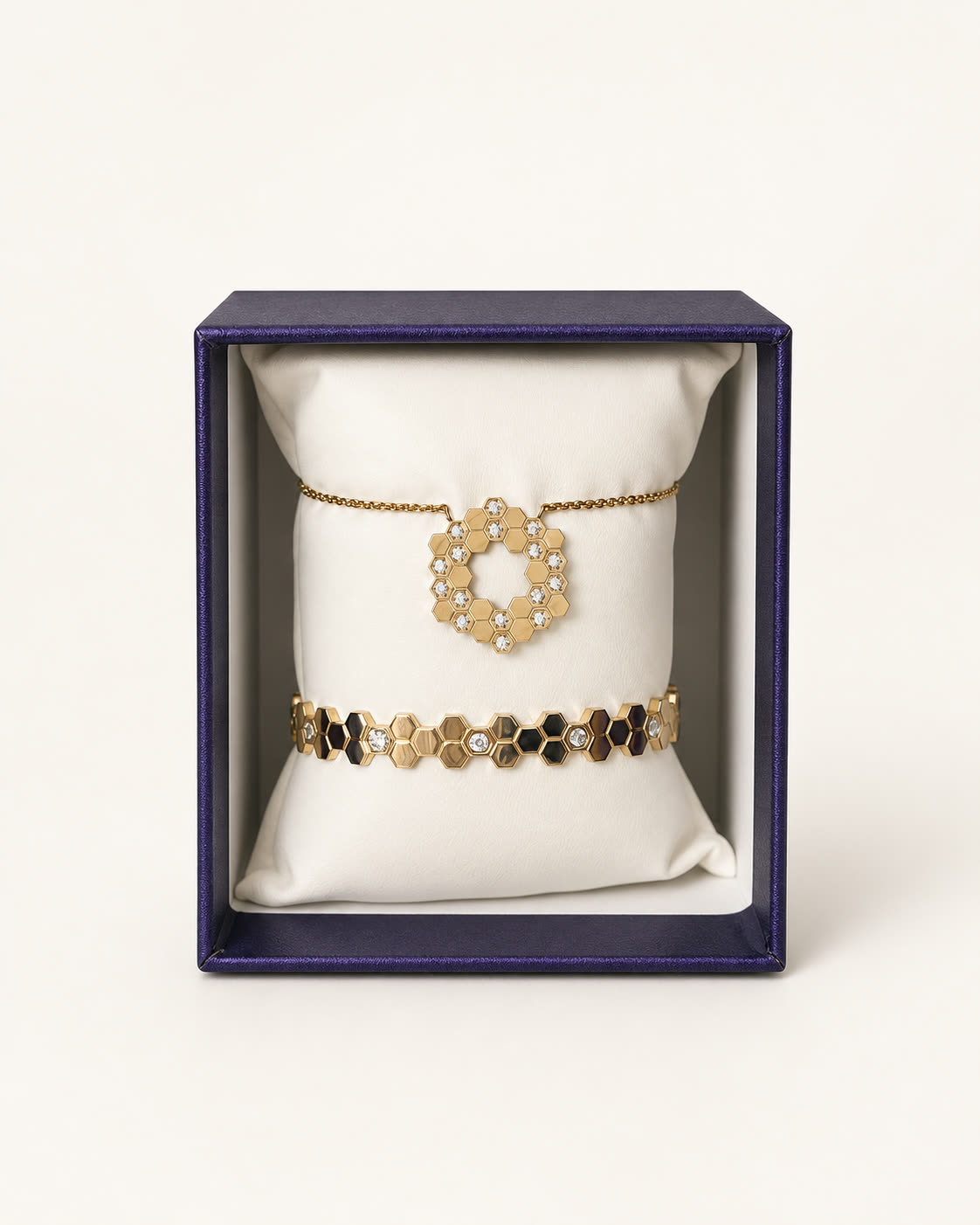 Ensemble Ruche : collier à médaillon alvéolé doré et bracelet assorti, présentés dans leur coffret